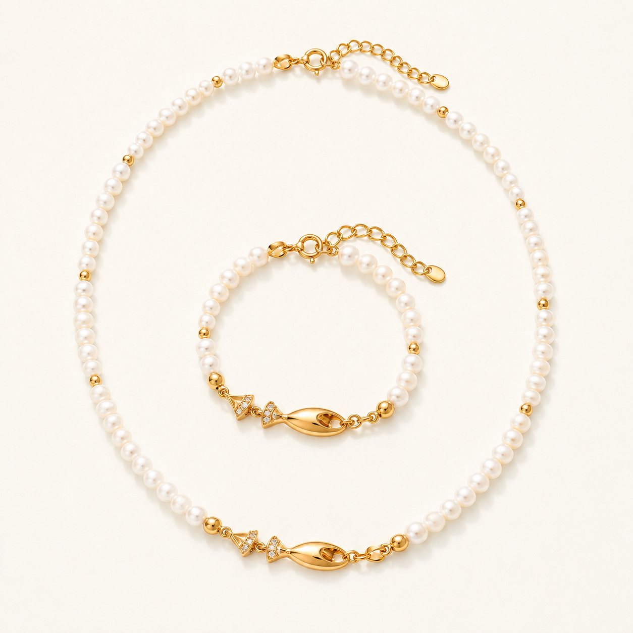 Vintage Gold natural pearl fish necklace and bracelet set on a white background