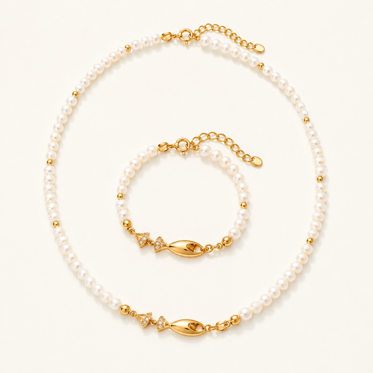 Vintage Gold natural pearl fish necklace and bracelet set on a white background