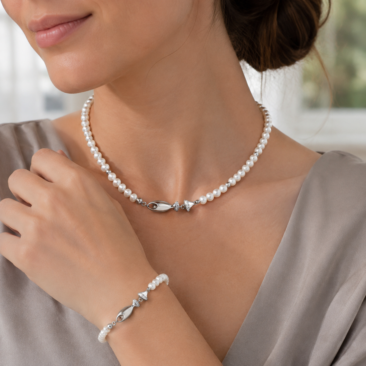 Close view of a model wearing the Silver natural pearl fish necklace and bracelet set