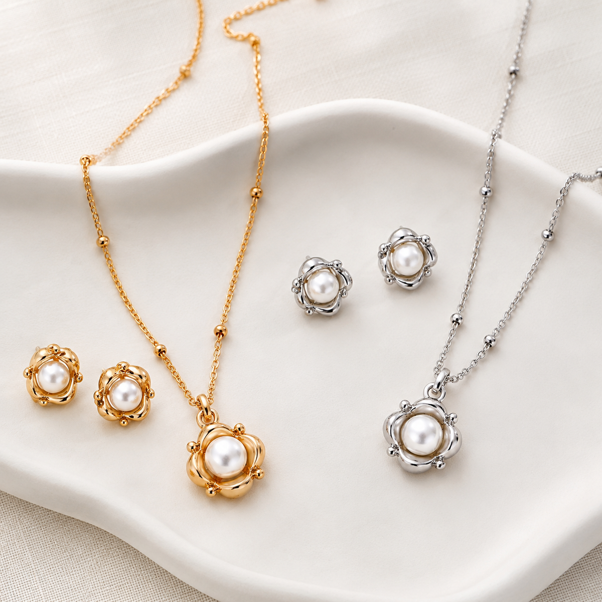 Vintage Gold and Silver Orbit Pearl Necklace and Stud Earring Jewelry Sets on an ivory display