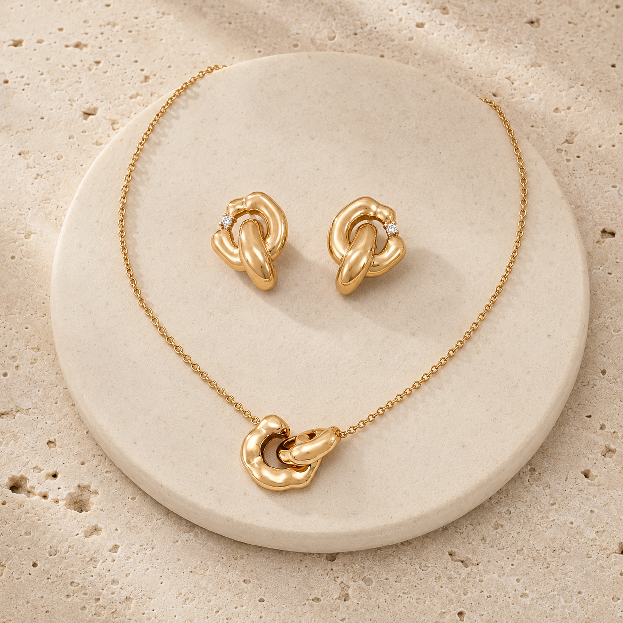Vintage Gold Interlocking Jewelry Set on a round stone display