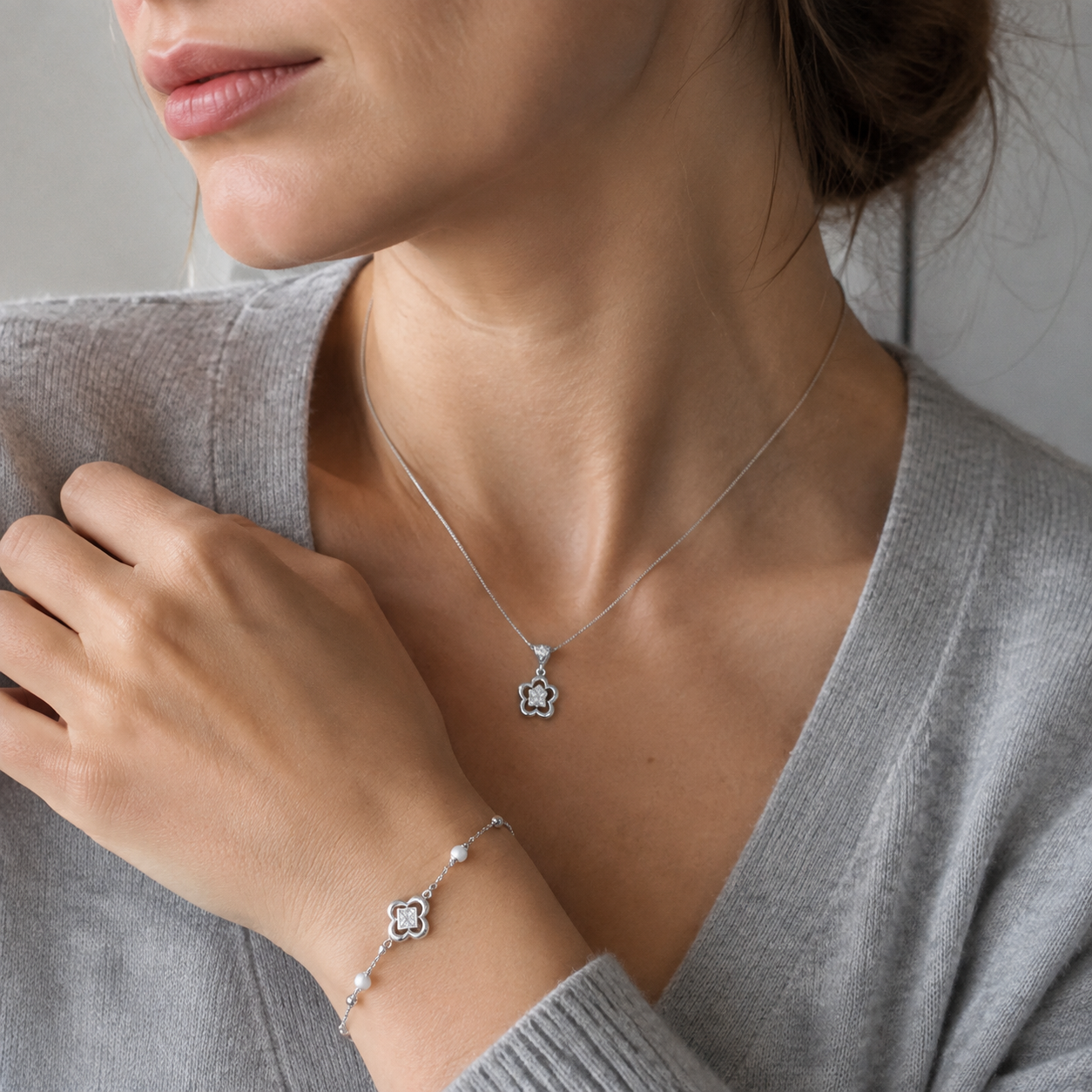 Close view of model wearing Silver clover necklace and bracelet jewelry set
