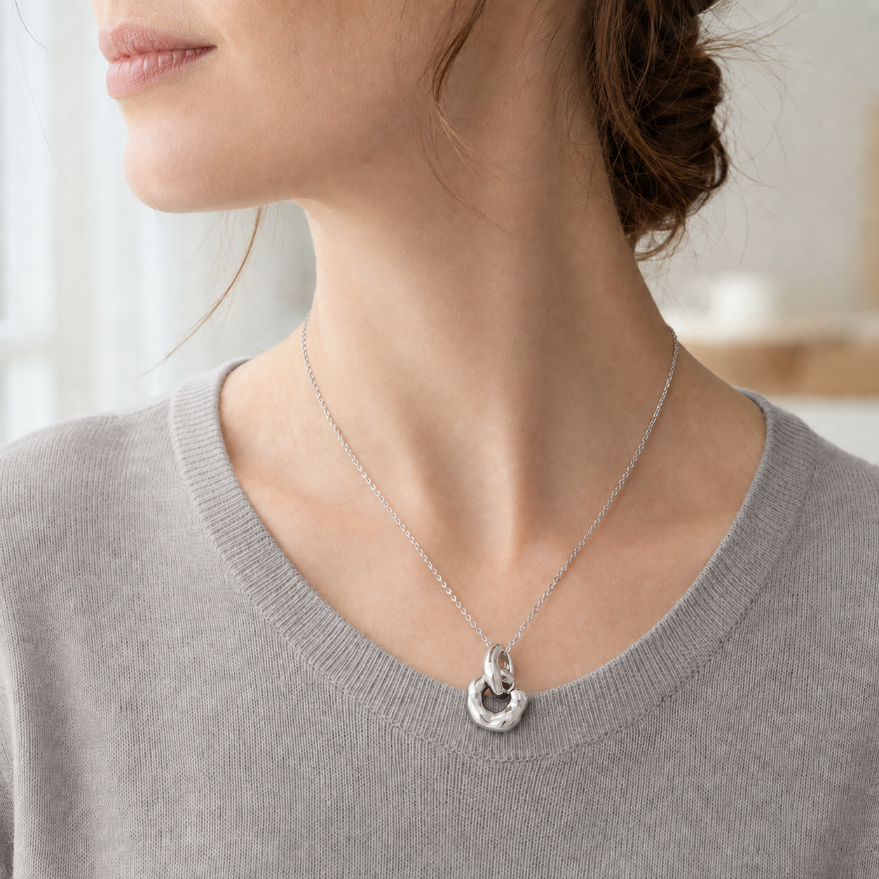Close neckline view of Silver Interlocking Pendant Necklace