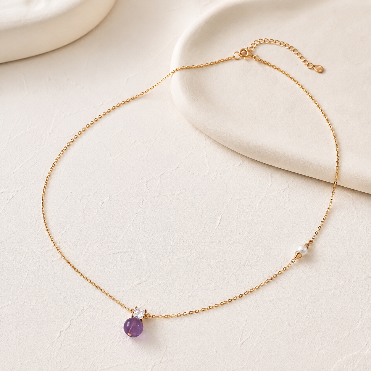 Amethyst and natural pearl necklace in Vintage Gold on an ivory display