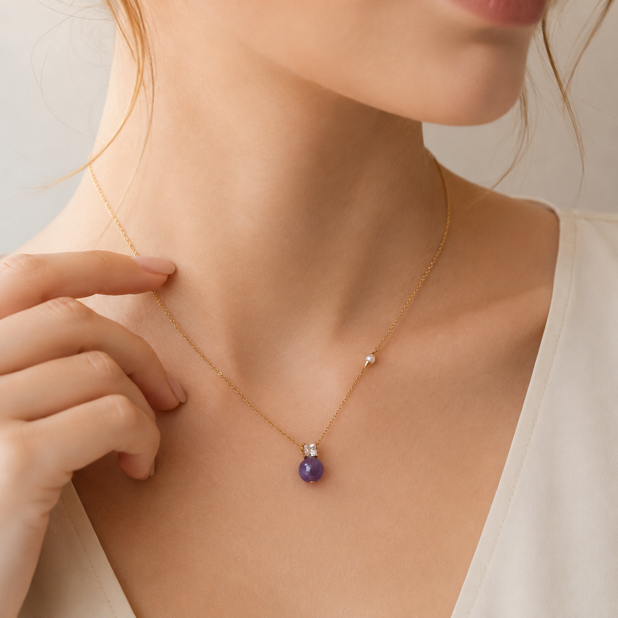 Close neckline view of the Amethyst and Pearl Necklace in Vintage Gold