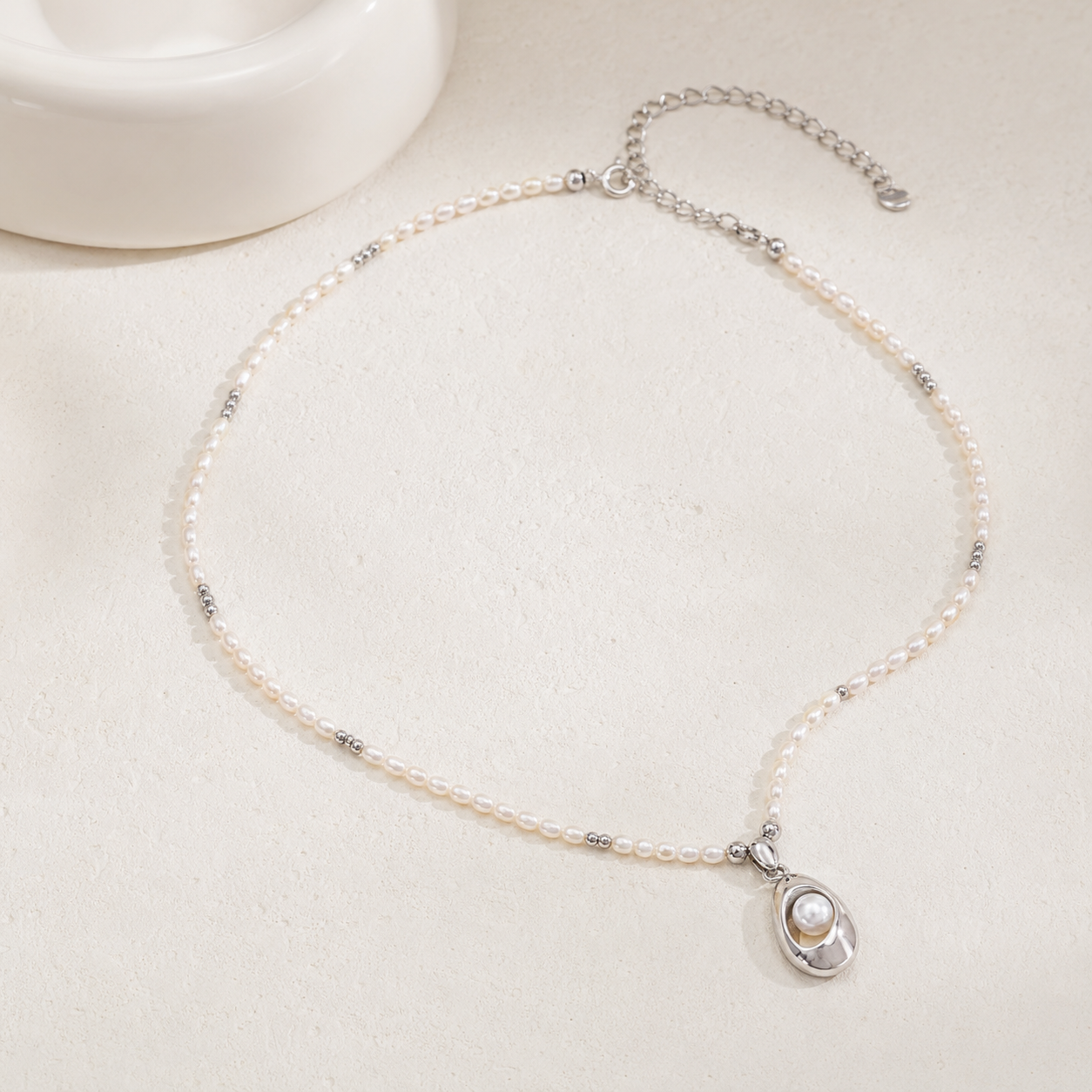 Silver natural pearl pendant necklace flat lay