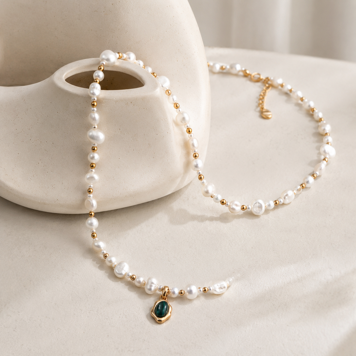 Vintage Gold natural pearl necklace draped around a ceramic vase