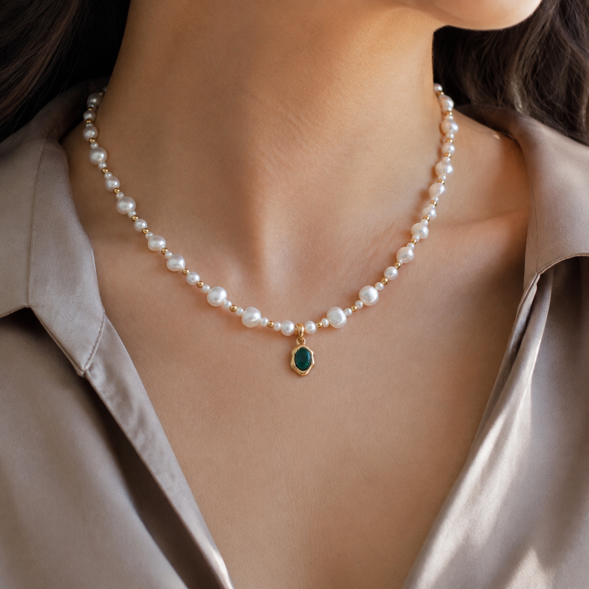 Close view of the Vintage Gold pearl and malachite pendant necklace worn with a satin blouse