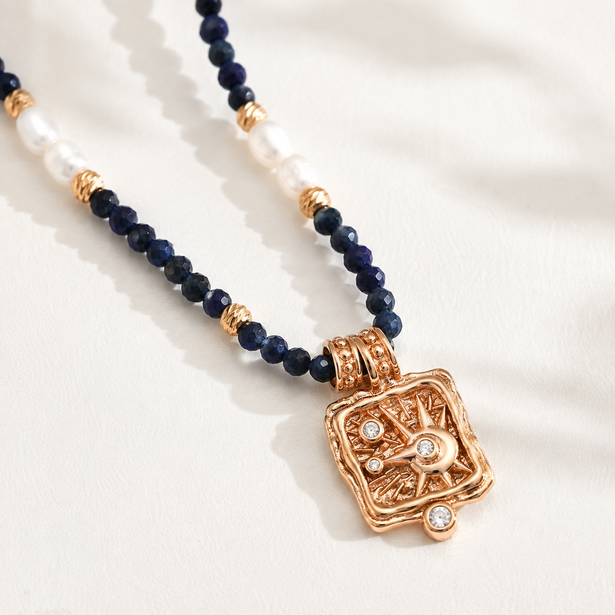 Close product view of the Vintage Gold celestial pendant with lapis lazuli and pearl beads