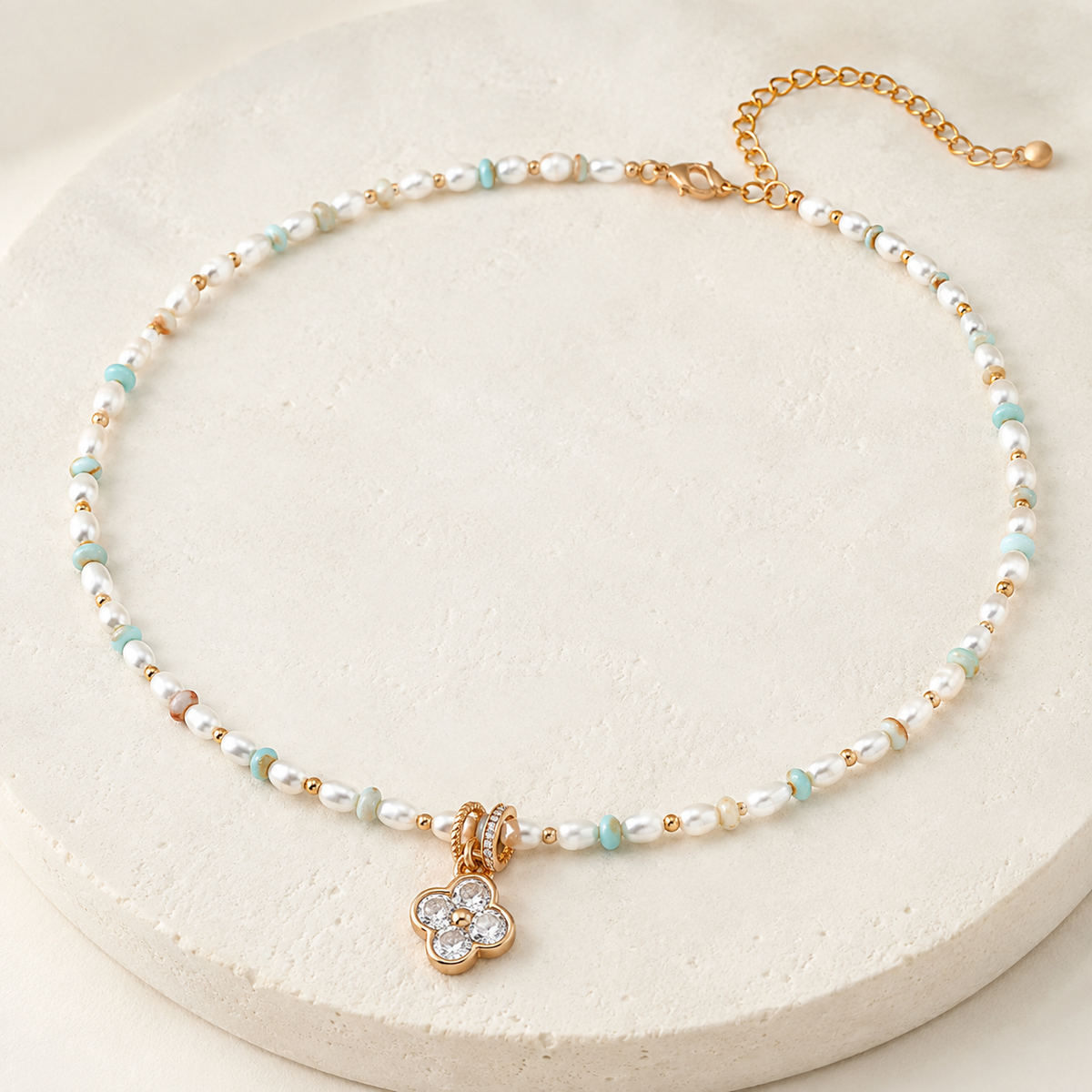 Full Vintage Gold Four Blessings Pearl Necklace on a round ivory display