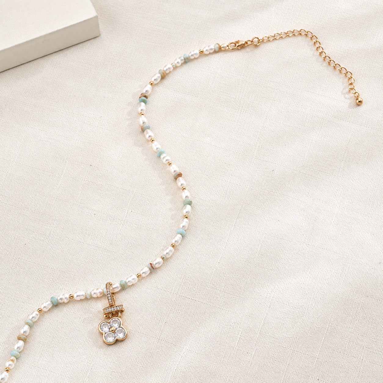 Vintage Gold Four Blessings Pearl Necklace laid flat with its adjustable extender chain
