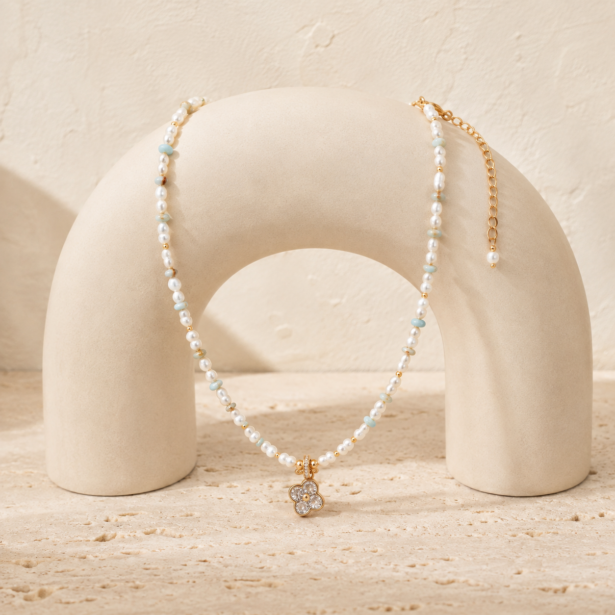 Vintage Gold Four Blessings Pearl Necklace displayed on an ivory arch