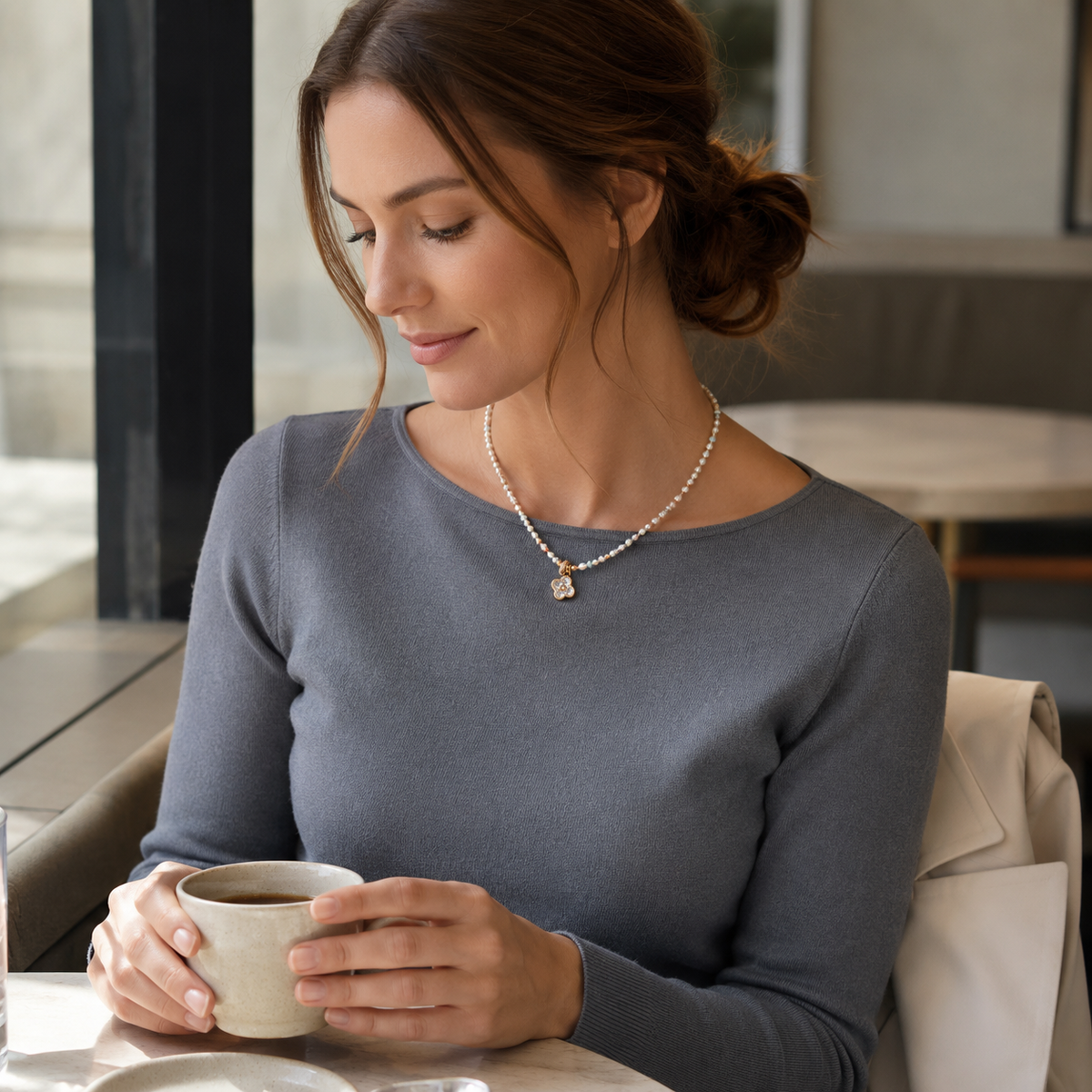 Model wearing the Vintage Gold Four Blessings Pearl Necklace with a grey knit