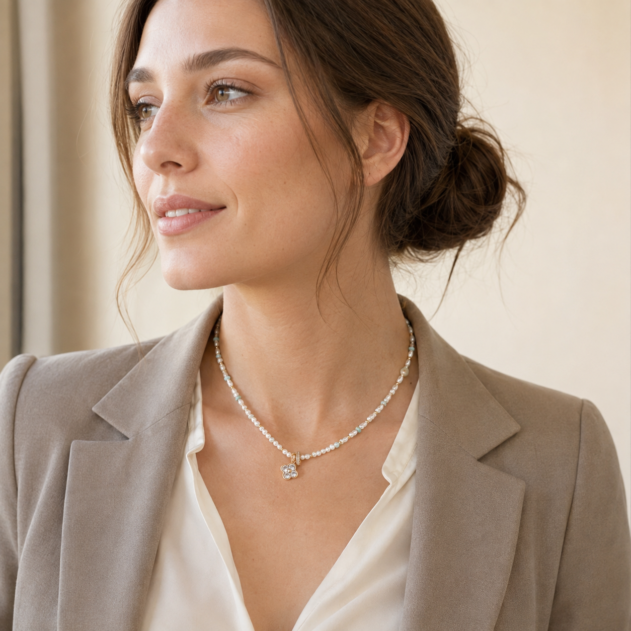 Model wearing the Vintage Gold Four Blessings Pearl Necklace with tailored neutral styling