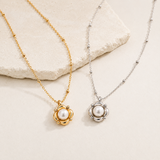 Vintage Gold and Silver Orbital Pearl Necklaces shown together on an ivory display