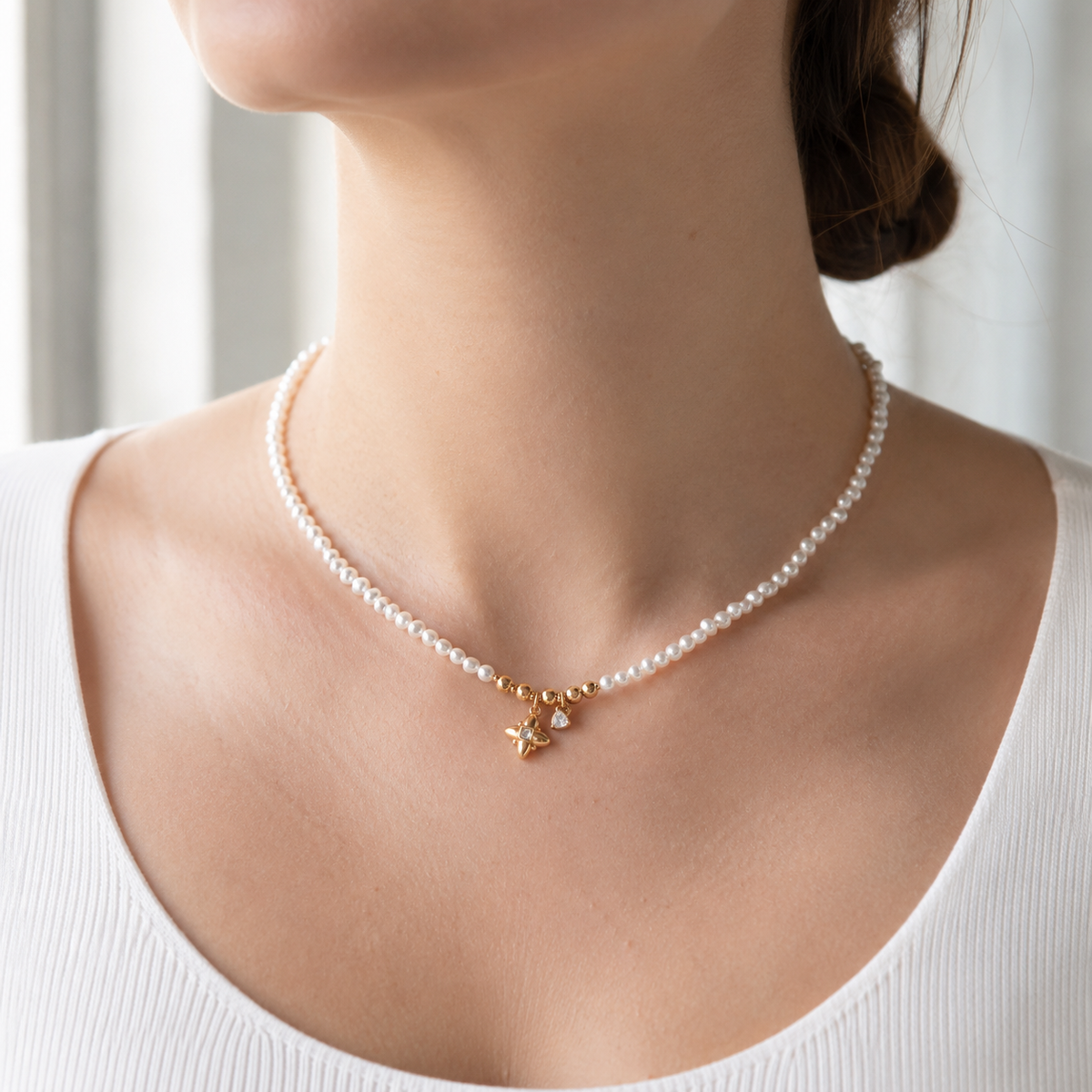 Close neckline view of Vintage Gold celestial natural pearl charm necklace