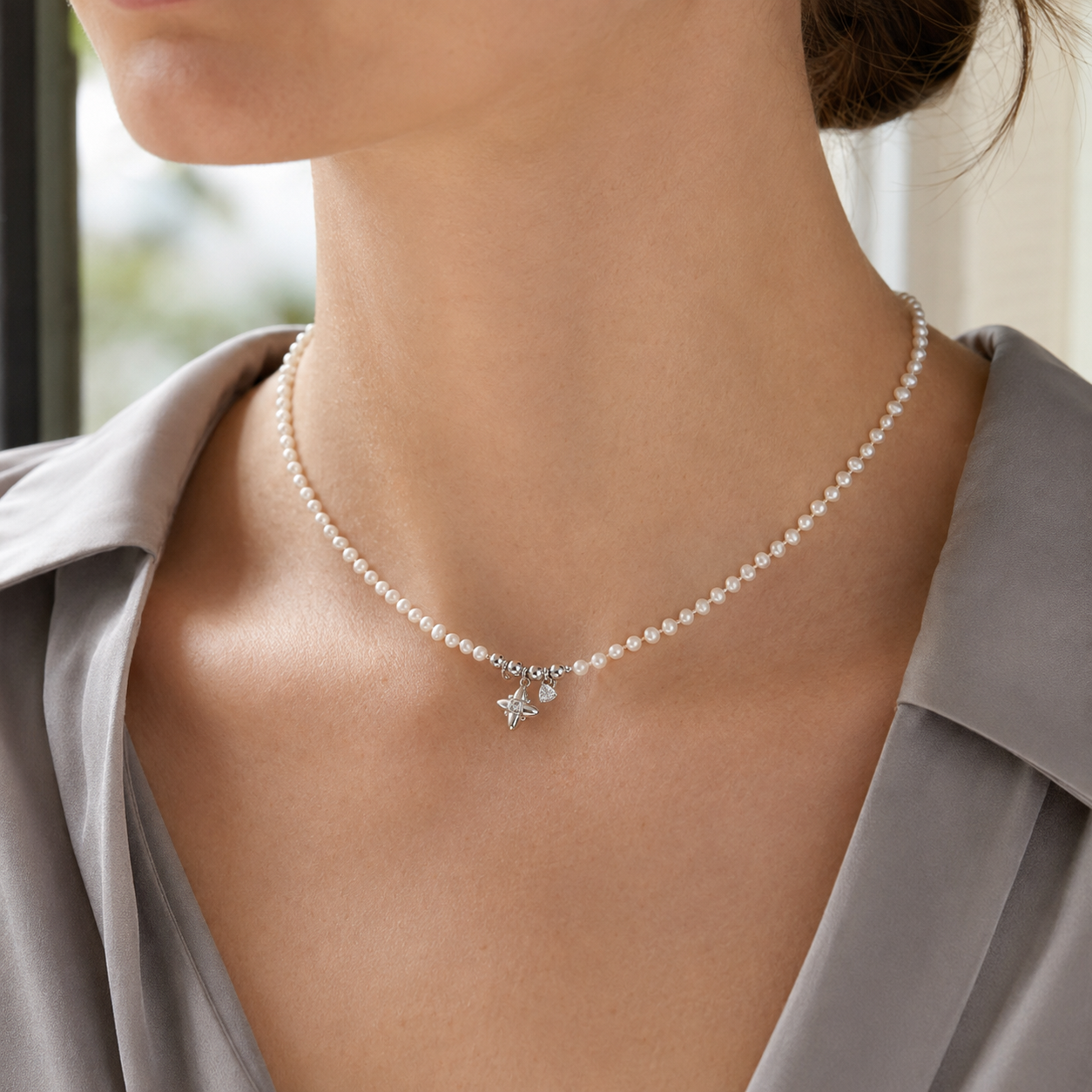 Close neckline view of Silver celestial natural pearl charm necklace