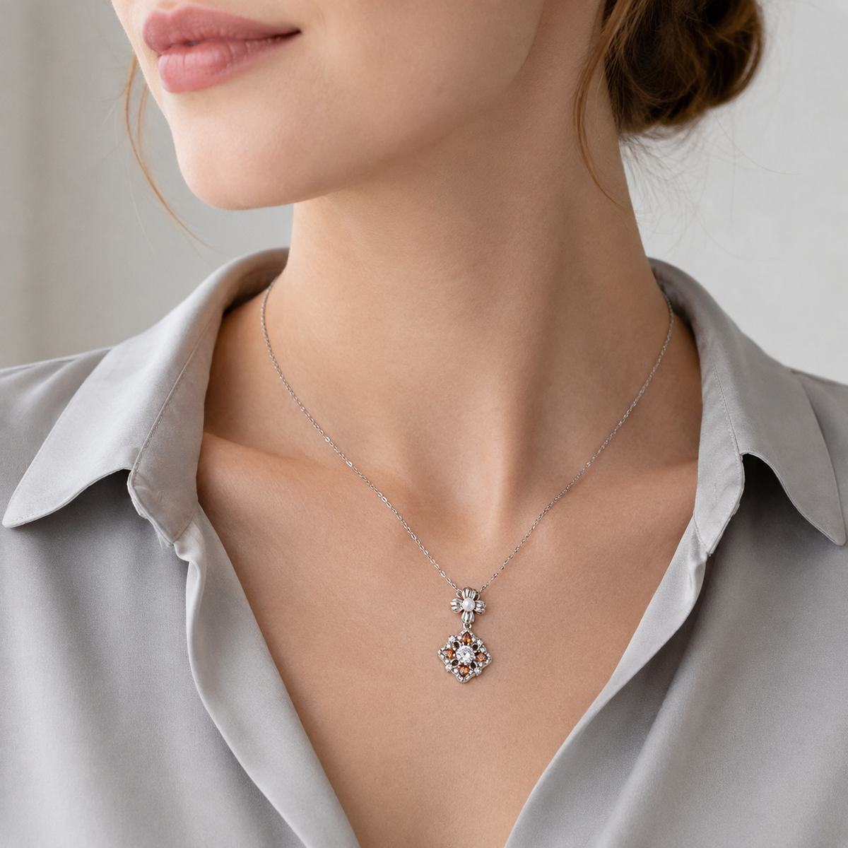 Close neckline view of the Silver auspicious bloom pearl pendant necklace