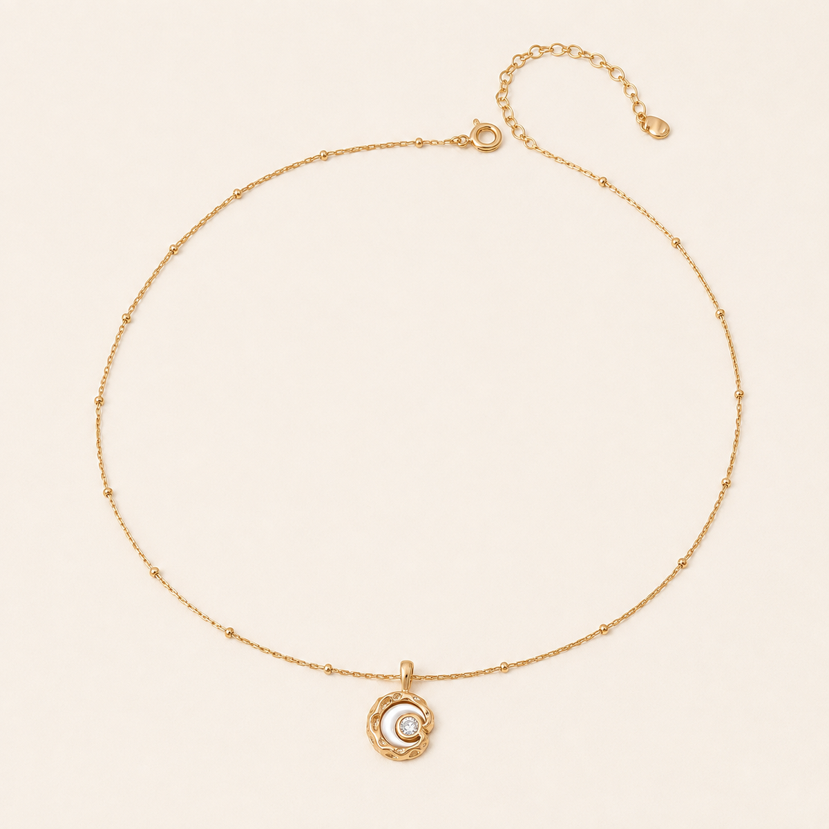 Vintage Gold mother-of-pearl moon pendant necklace on an ivory background