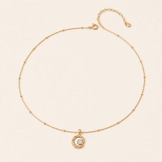 Vintage Gold mother-of-pearl moon pendant necklace on an ivory background
