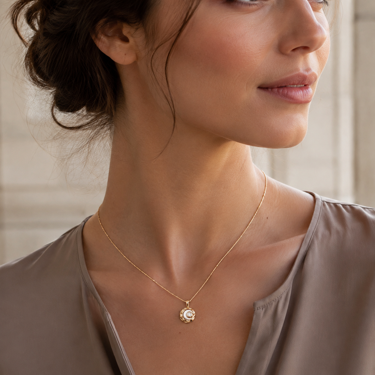 Close neckline view of the Vintage Gold mother-of-pearl moon pendant necklace with a satin blouse