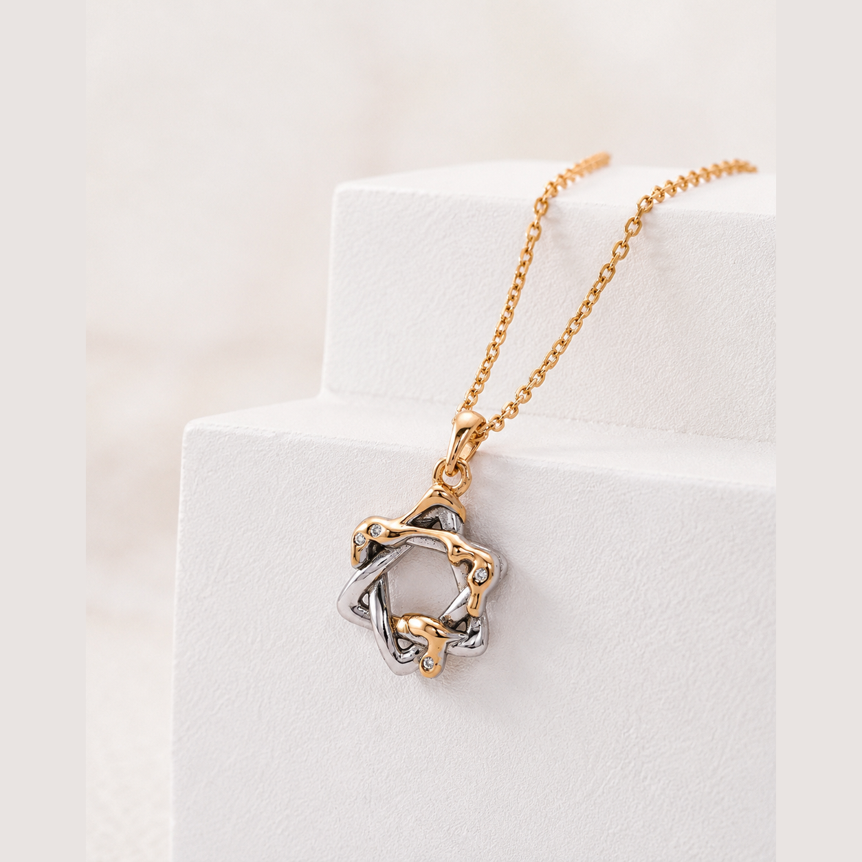 Close-up of the mixed-tone Interwoven Star pendant with cubic zirconia
