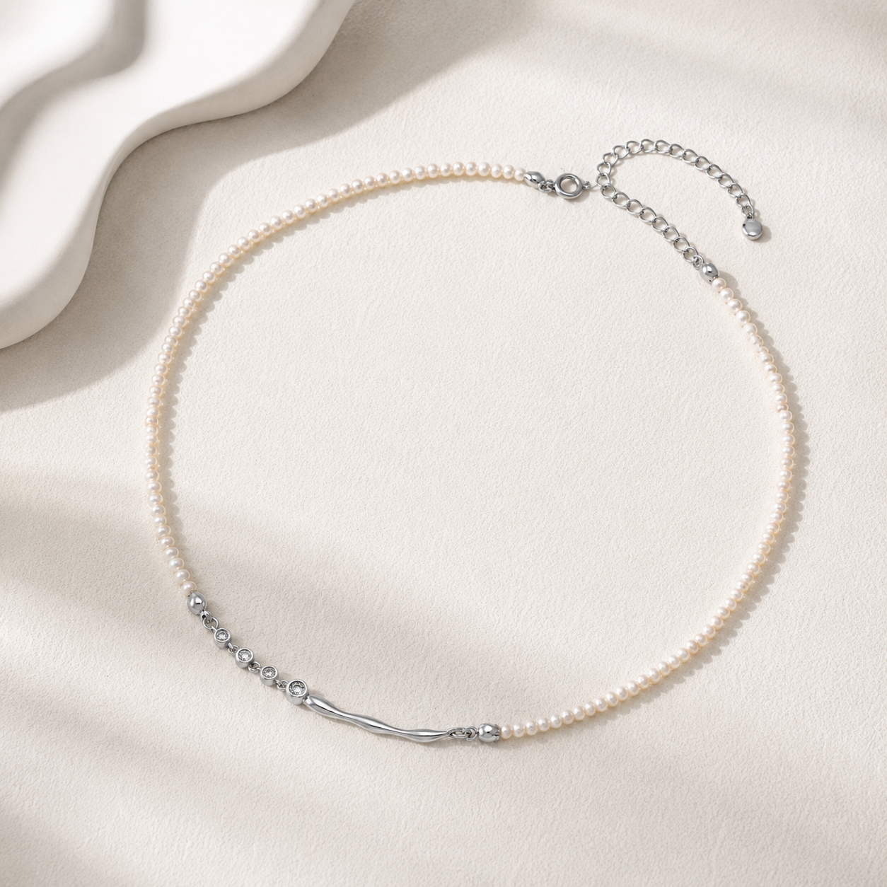 Silver fluid zircon natural pearl necklace flat lay