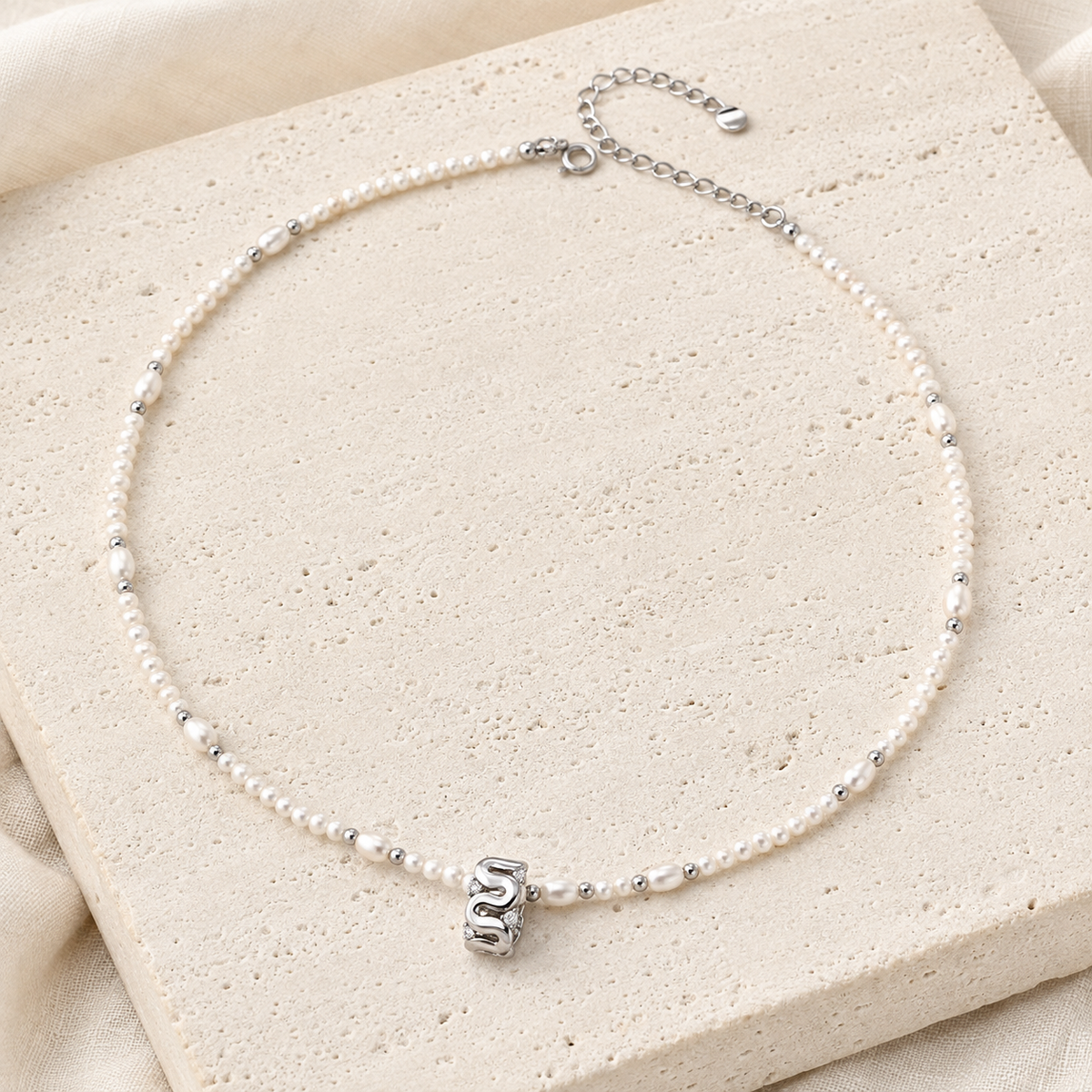 Silver sculpted natural pearl zircon necklace flat lay