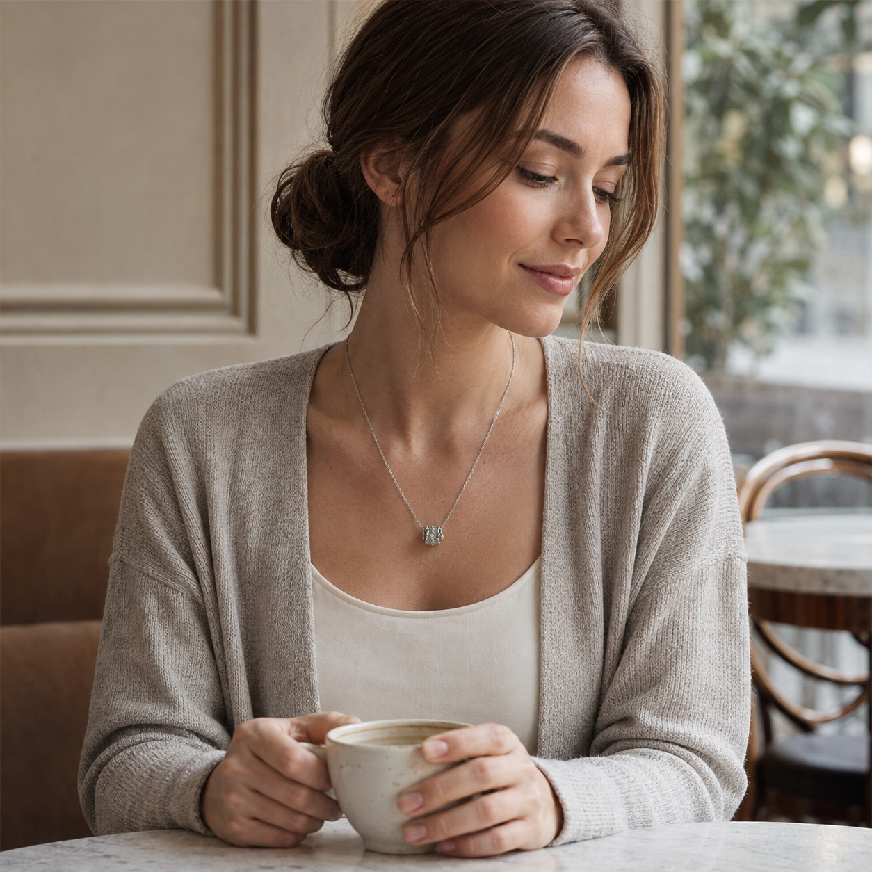 Model wearing Silver Vintage Zircon Pendant Necklace with a light cardigan