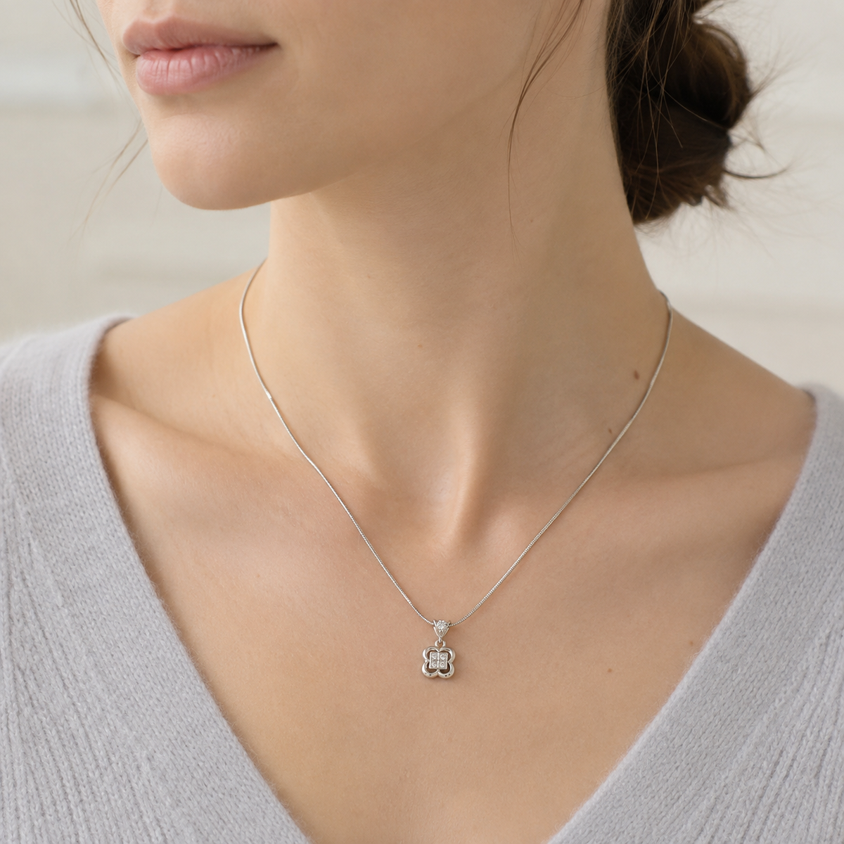 Close-up of model wearing Silver clover zircon pendant necklace