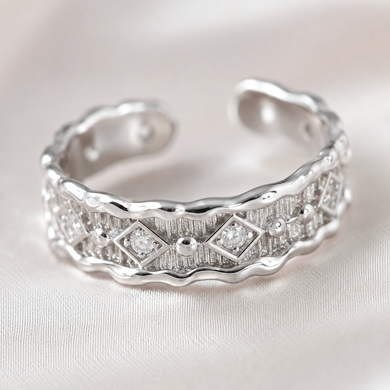 Close view of Silver Vintage Zircon Ring on ivory satin