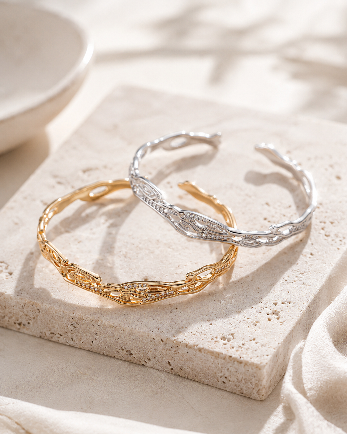 Vintage Gold and Silver galaxy zircon bangles on a stone display