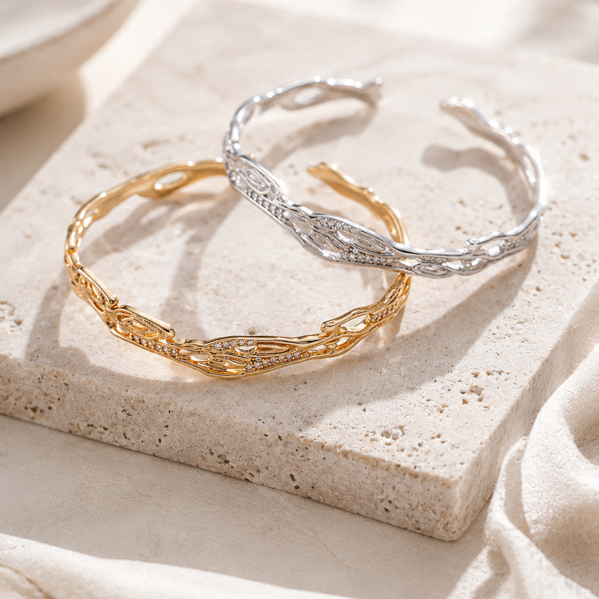 Vintage Gold and Silver galaxy zircon bangles on a stone display