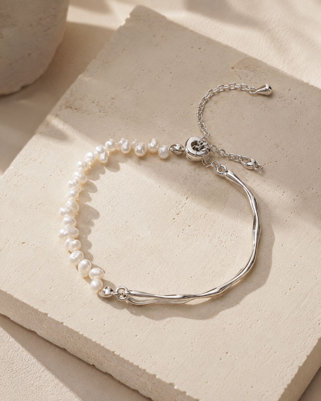 Platinum tone natural pearl bracelet in warm daylight